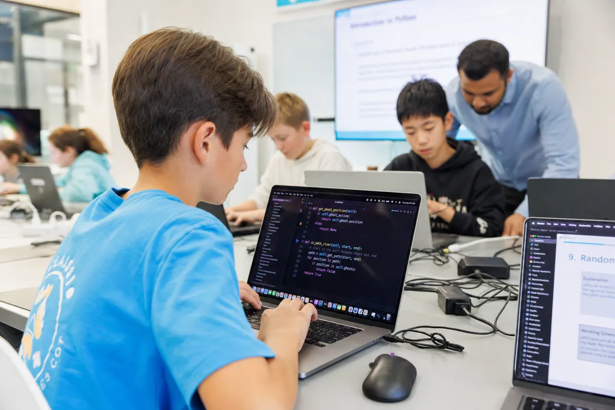 Students learning Python programming in a guided class
